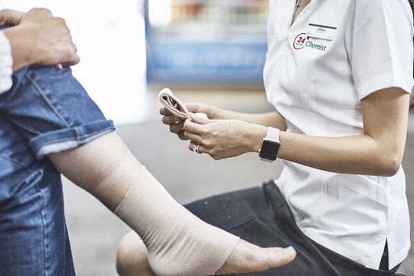 Person being fitted with a lower leg compression garment