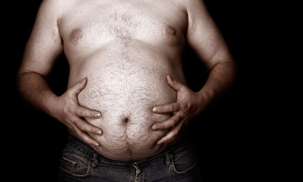 Close up of man's hands on his large stomach