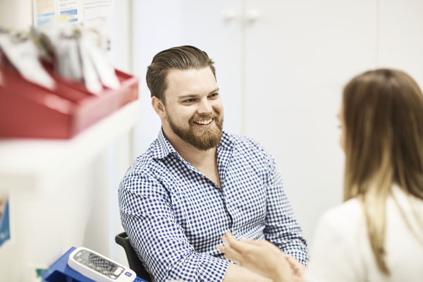 Smiling man speaking with Pharmacist