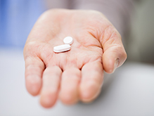 Close up of hand with some pills in the open palm