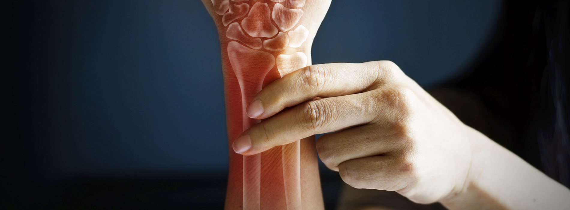 Close up of woman holding her wrist with bones superimposed on it