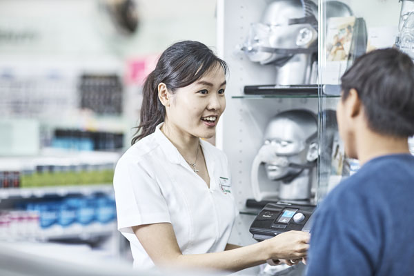 Pharmacist advising a man on sleep apnoea treatments