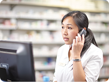 Pharmacist speaking on phone with customer
