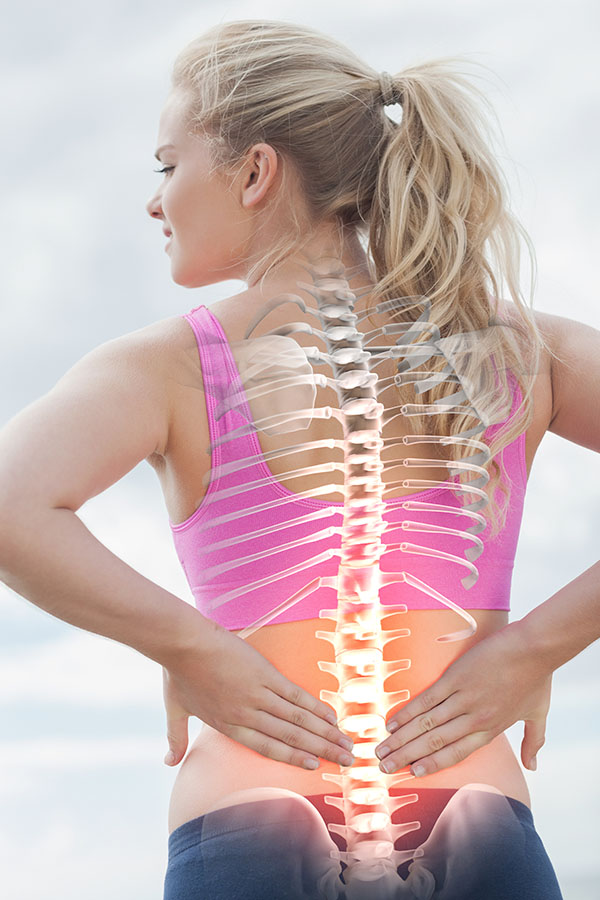 Superimposed back bones on a woman as she faces away from us